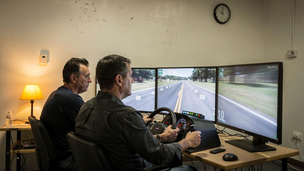 Instructor and driver reviewing a replay breakdown at the simulation console